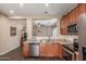 The open-concept kitchen includes stainless steel appliances, granite countertops, and an open view to the living area at 40089 W Bonneau St, Maricopa, AZ 85138