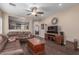 Cozy living room showing wood floors, comfortable furniture, and easy access to the kitchen at 40089 W Bonneau St, Maricopa, AZ 85138
