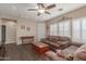 Inviting living room featuring a ceiling fan, comfortable sofa, and lots of natural light at 40089 W Bonneau St, Maricopa, AZ 85138