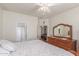The main bedroom includes a dresser, a ceiling fan, and an ensuite bathroom at 40089 W Bonneau St, Maricopa, AZ 85138
