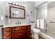 Well-lit bathroom featuring a vanity with a sink, a toilet, and a glass-enclosed shower at 4024 W Griswold Rd, Phoenix, AZ 85051