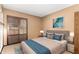 Cozy bedroom with neutral walls, plantation shutters, and a comfortable queen-sized bed at 4024 W Griswold Rd, Phoenix, AZ 85051
