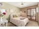 Charming bedroom with a comfortable bed, vintage decor, and a shuttered window at 4024 W Griswold Rd, Phoenix, AZ 85051