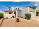 Charming home featuring a well-maintained gravel yard and a covered entrance under a partly cloudy sky at 4024 W Griswold Rd, Phoenix, AZ 85051