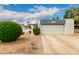 Charming home featuring a well-maintained yard and attached garage under a partly cloudy sky at 4024 W Griswold Rd, Phoenix, AZ 85051
