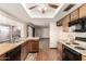 Cozy kitchen featuring wood cabinets, wood-style floors, and a window over the sink at 4024 W Griswold Rd, Phoenix, AZ 85051