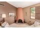 Cozy living room features a unique fireplace, wall decor, and a bright window at 4024 W Griswold Rd, Phoenix, AZ 85051