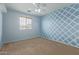 Cozy bedroom with carpet, ceiling fan and a large window with blinds at 41158 W Cahill Dr, Maricopa, AZ 85138