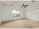 Spacious bedroom with carpet floors, white walls, a ceiling fan, and windows with blinds at 41158 W Cahill Dr, Maricopa, AZ 85138