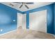 Bright bedroom features a ceiling fan and a closet with sliding doors at 41158 W Cahill Dr, Maricopa, AZ 85138