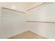 Walk-in closet with neutral carpet, white walls, and built-in shelving at 41158 W Cahill Dr, Maricopa, AZ 85138