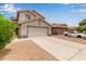 Inviting two-story home features desert landscaping, a two-car garage, and extended driveway at 41158 W Cahill Dr, Maricopa, AZ 85138