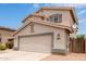 Lovely two-story home with a tile roof, low maintenance landscaping, and an attached two-car garage at 41158 W Cahill Dr, Maricopa, AZ 85138