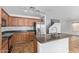 Kitchen with stainless steel appliances, oak cabinetry, a breakfast bar, and a neutral color palette at 41158 W Cahill Dr, Maricopa, AZ 85138