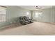Large living room features neutral walls, carpet floors, a ceiling fan, and a comfortable leather sofa at 41158 W Cahill Dr, Maricopa, AZ 85138