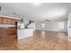 Bright, open living space with tile floors seamlessly connecting the kitchen and living areas at 41158 W Cahill Dr, Maricopa, AZ 85138