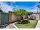 Landscaped backyard with artificial turf, desert trees, and privacy fencing at 4242 N 44Th St, Phoenix, AZ 85018