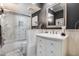 Elegant bathroom with marble shower, gray walls, and white beadboard vanity at 4242 N 44Th St, Phoenix, AZ 85018