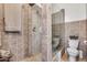Bathroom featuring a walk-in shower with tan tiles, toilet, and fish decor at 4242 N 44Th St, Phoenix, AZ 85018