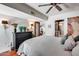 Cozy bedroom with hardwood floors, a dark dresser, and interior access to a full bathroom at 4242 N 44Th St, Phoenix, AZ 85018
