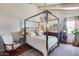 Well-lit bedroom with a canopy bed, wood floors, and large windows at 4242 N 44Th St, Phoenix, AZ 85018