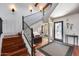 Inviting foyer featuring wood floors, a staircase with iron railings, and a view to the home's entrance at 4242 N 44Th St, Phoenix, AZ 85018