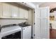 Laundry area with appliances, storage cabinets, and white trim at 4242 N 44Th St, Phoenix, AZ 85018
