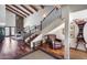 Spacious living area with wood floors, beamed ceilings, and a fireplace with stone surround at 4242 N 44Th St, Phoenix, AZ 85018