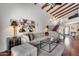 Bright living room showcasing beamed ceilings, an elegant painting, and comfortable furnishings at 4242 N 44Th St, Phoenix, AZ 85018