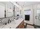 Stylish bathroom featuring dual sinks with a marble countertop and decorative tile backsplash, plus a glass shower at 4320 N 35Th St, Phoenix, AZ 85018