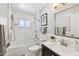 Bright bathroom with a shower-tub combo, white subway tile, and a sleek vanity with a modern sink at 4320 N 35Th St, Phoenix, AZ 85018