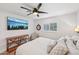 Bright bedroom featuring a ceiling fan, TV, natural light, and a comfortable bed with textured bedding at 4320 N 35Th St, Phoenix, AZ 85018