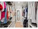 Spacious walk-in closet with custom shelving, hanging racks, and a full-length mirror for ample storage at 4320 N 35Th St, Phoenix, AZ 85018