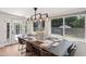 Inviting dining area with a rustic wooden table, stylish lighting, and ample natural light at 4320 N 35Th St, Phoenix, AZ 85018