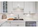 Close-up view of a modern kitchen sink, stainless steel appliances, and white countertops at 4320 N 35Th St, Phoenix, AZ 85018