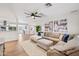 Bright and spacious living room with an elegant sectional sofa, ceiling fan, and hardwood floors at 4320 N 35Th St, Phoenix, AZ 85018