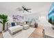 Bright and spacious living room with an elegant sectional sofa, ceiling fan, and hardwood floors at 4320 N 35Th St, Phoenix, AZ 85018