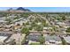 Picturesque aerial view of a lush neighborhood with palm trees, distant mountains, and beautiful homes at 4320 N 35Th St, Phoenix, AZ 85018