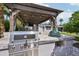 Gourmet outdoor kitchen featuring a built-in grill and a Big Green Egg smoker, ideal for outdoor cooking at 4320 N 35Th St, Phoenix, AZ 85018
