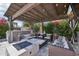 Inviting outdoor patio with a fire pit, comfortable seating, bar area, and a pergola with ambient lighting at 4320 N 35Th St, Phoenix, AZ 85018