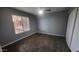 A serene bedroom with wood floors, ample closet space, and a bright window at 4704 E Paradise Village N Pkwy # 211, Phoenix, AZ 85032