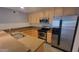 Contemporary kitchen boasts stainless appliances, wood cabinets, and stylish backsplash at 4704 E Paradise Village N Pkwy # 211, Phoenix, AZ 85032