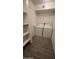 Convenient laundry room with full-size washer and dryer hookups and built-in shelving at 4704 E Paradise Village N Pkwy # 211, Phoenix, AZ 85032