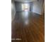 A spacious living room features hardwood floors and a balcony with lots of natural light at 4704 E Paradise Village N Pkwy # 211, Phoenix, AZ 85032