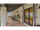 Relaxing back porch featuring rocking chairs, stylish decor, and French doors leading to a tranquil outdoor space at 4824 E Hummingbird Ln, Paradise Valley, AZ 85253