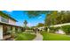 Expansive backyard with a stone path, leading to a cozy seating area with an umbrella and pool in the background at 4824 E Hummingbird Ln, Paradise Valley, AZ 85253