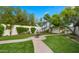 Lush backyard featuring manicured lawns, a charming fountain, and a welcoming garden archway at 4824 E Hummingbird Ln, Paradise Valley, AZ 85253