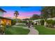 Lush backyard with a fountain, winding pathways, and pool at 4824 E Hummingbird Ln, Paradise Valley, AZ 85253