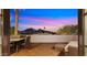 Private balcony with desert views, complete with an outdoor dining set and seating area at 4824 E Hummingbird Ln, Paradise Valley, AZ 85253