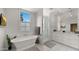 Elegant bathroom featuring a soaking tub, walk-in shower, and double vanity at 4824 E Hummingbird Ln, Paradise Valley, AZ 85253